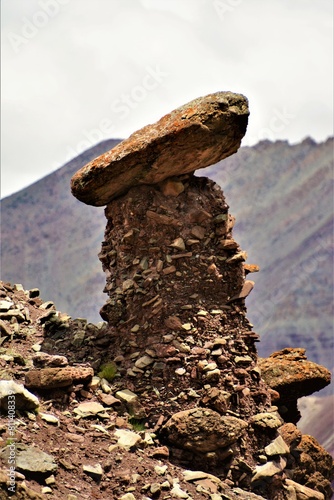 An isolated rock structure formed by erosion and weathering sculpting the existing rock, seen from the trail leading from the mountain pass Kongmaru La to Chogdo village (Ladakh region, India)