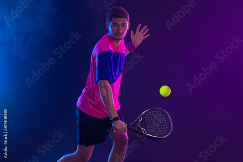 Padel Tennis Player with Racket in Hand. Paddle tenis, on a blue background. Download in high resolution. © Mike Orlov