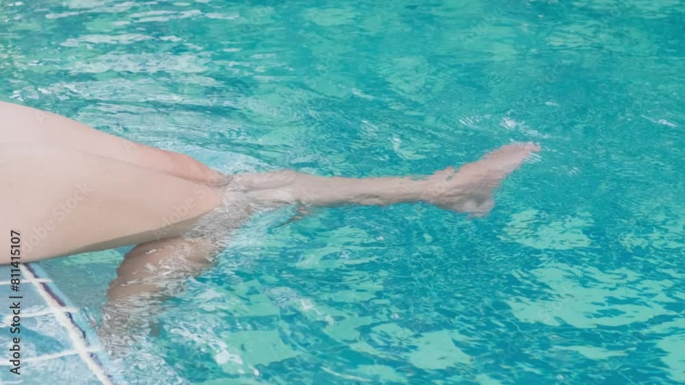 girl in pool swings her legs into water, slow motion
girl in pool swings her legs into water, slow motion