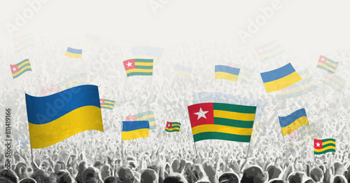 People waving flag of Togo and Ukraine, symbolizing Togo solidarity for Ukraine.