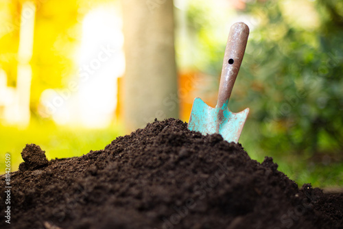 Garden shovel, fresh soil. Summerday, outside.
