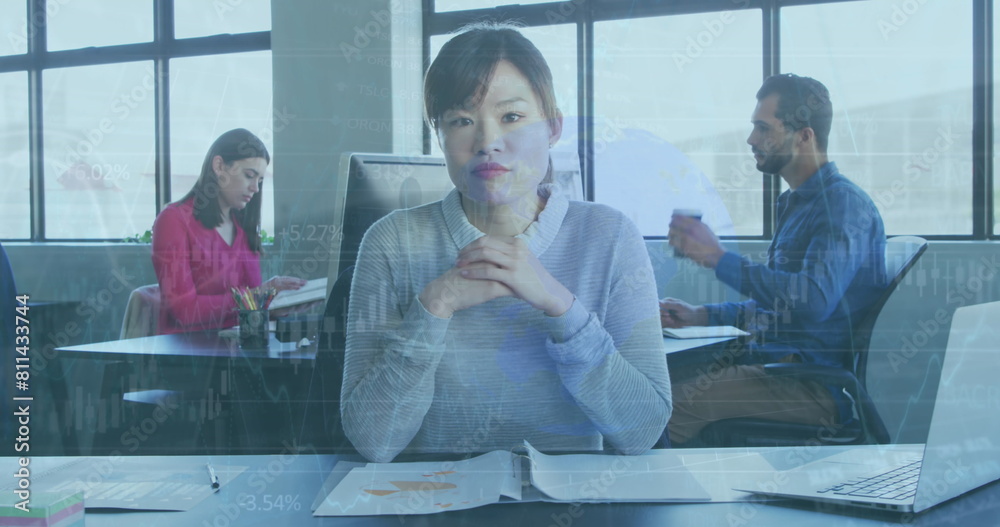Fototapeta premium Diverse colleagues focusing on work, Asian woman in front
