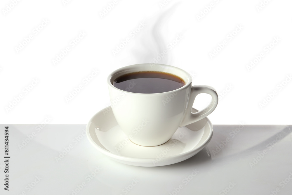 Steaming coffee in cup on table against white background Steaming coffee in cup on table against white background
