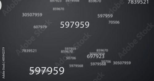 Image of numbers changing over grey background photo