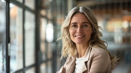 Genuine Smile of Mature Businesswoman with Disability in Wheelchair: Office Inclusion Concept in Wide Shot with Depth of Field