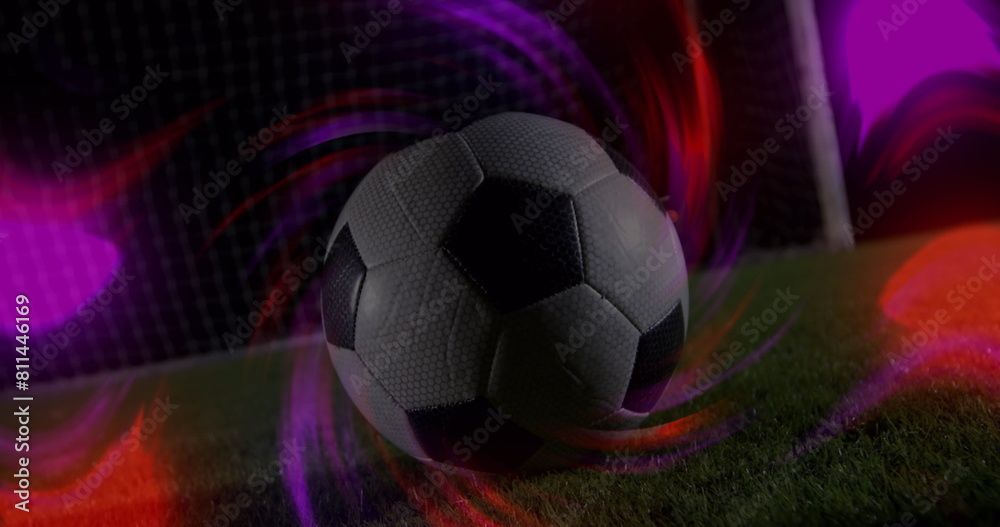 Fototapeta premium Image of light trails over male soccer player