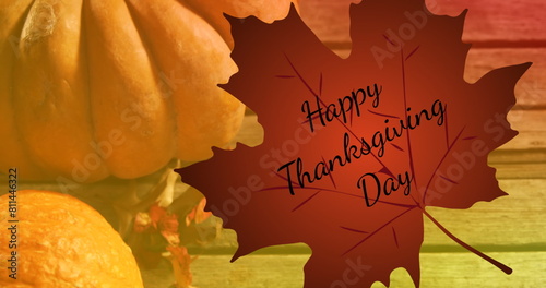 Image of happy thanksgiving day text over autumn leaf and pumpkins on wooden background