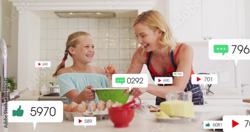 Image of icons with growing number over caucasian woman and her daughter baking together