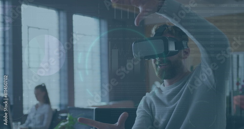 Image of financial data processing over caucasian businessman using vr headset in office