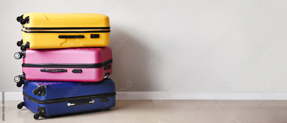 Packed suitcases near light wall Packed suitcases near light wall