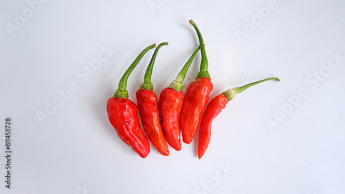 Photo of chilies stacked with white background.