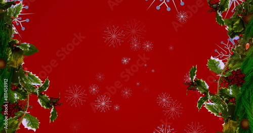 Image of snowflakes over fir tree branches on red background
