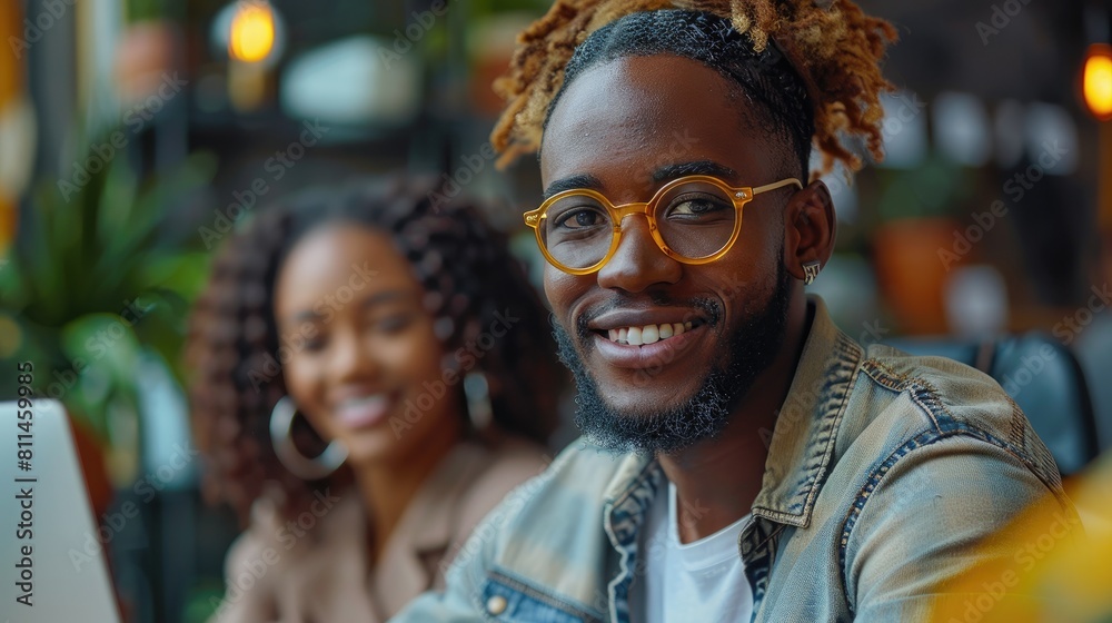 Smiling young man with dreadlocks sitting in a cafe with a friend. Smiling young man with dreadlocks sitting in a cafe with a friend.