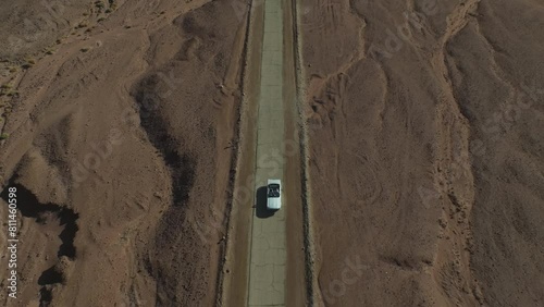Aerial video in Timna Park above a vehicle traveling on a desert road. Israel