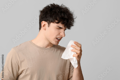 Young man with runny nose o...