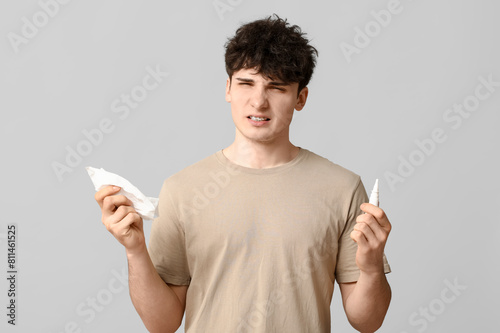Young man with nasal drops ...