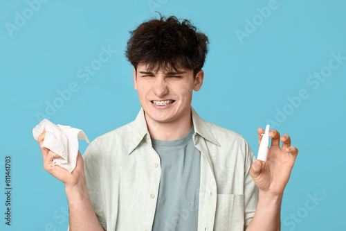 Young man with nasal drops ...
