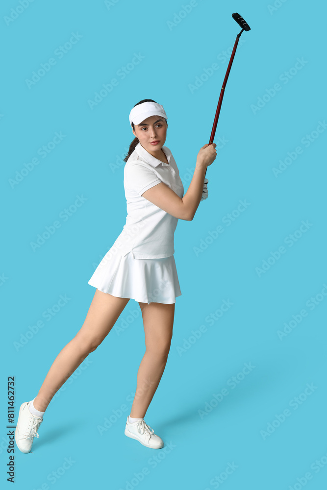 Beautiful female golfer on blue background Beautiful female golfer on blue background