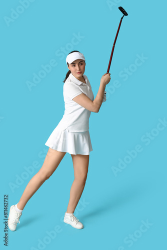 Beautiful female golfer on blue background