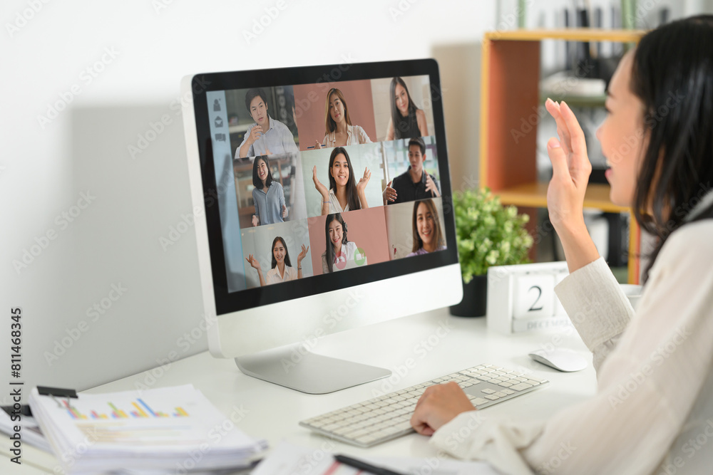 Side view smiling young woman having virtual call meeting during remote working from home Side view smiling young woman having virtual call meeting during remote working from home