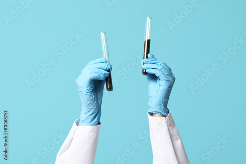 Scientist hands in blue glo...