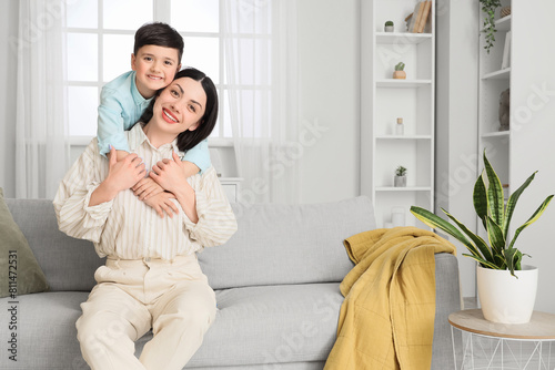 Cute little boy hugging his...