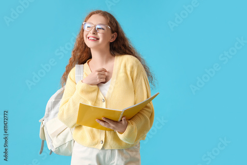 Happy female student with b...