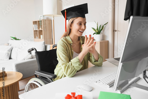 Online graduation and remote education, happy student in wheelchair wearing m...