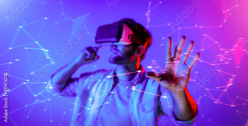 Smart man looking data or connecting with big data or virtual reality by using goggle or VR headset. Caucasian person exploring metaverse world and touching simulated program. Technology. Deviation.