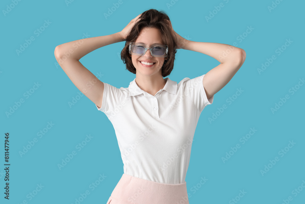 Pretty young woman with sunglasses on blue background Pretty young woman with sunglasses on blue background