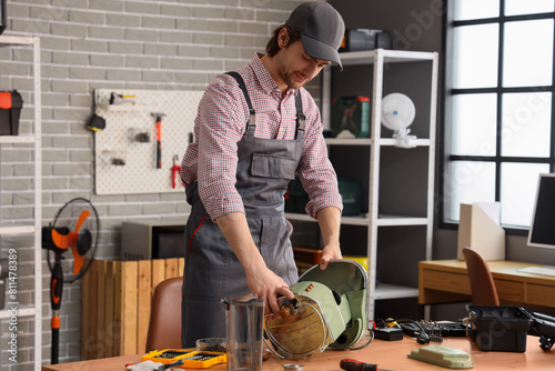 Male worker repairing coffe...