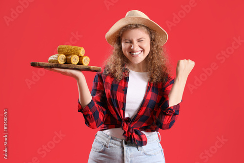 Happy young woman with corn...