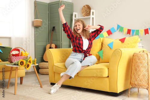 Happy young woman sitting o...