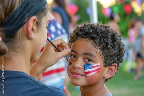 Young Hispanic boy getting an American flag painted on his cheek at an outdoor event. © evgenia_lo