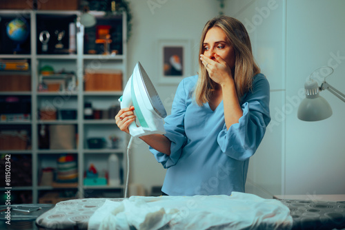 Vászonkép Stressed Woman Making a Mistake Ironing Clothes