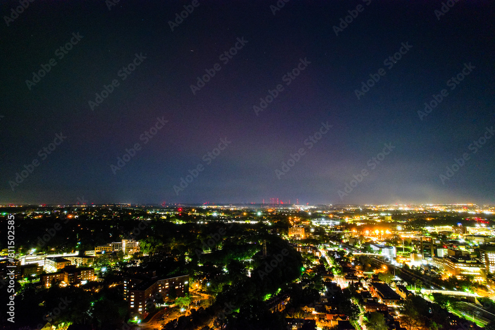 Naklejka premium An aerial view of the Aurora Borealis over Cleveland, Ohio on May 5th, 2024. Downtown is in view, the bright lights of the city subduing the aurora's colors.