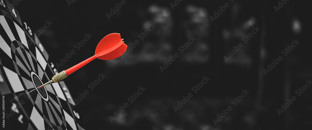 Target bullseye or Bulls eye or dartboard has red dart arrow throw hitting the center of a shooting for financial business targeting planning growth and aim to winner goal of business win concept. Target bullseye or Bulls eye or dartboard has red dart arrow throw hitting the center of a shooting for financial business targeting planning growth and aim to winner goal of business win concept.