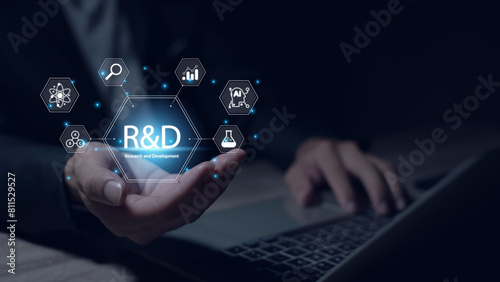 Research and development, businessman uses laptop with R and D icons on virtual screen for research and development, technology, science, business