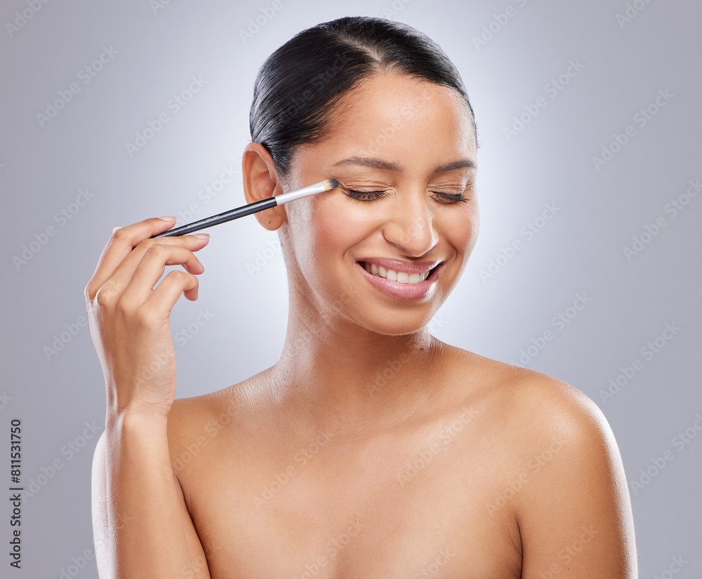 Woman, face and makeup with brush, beauty and cosmetic tools and eyes closed in studio background. Model, person and happy or smile for transformation or eyeshadow, body and health for self care