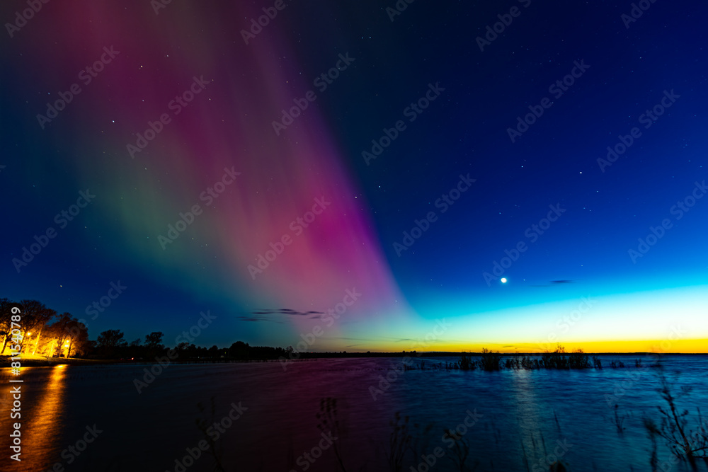 Northern Lights over Lake Burtnieks. Aurora Borealis or Northern Lights Latvia. Aurora reflection in the water at night
