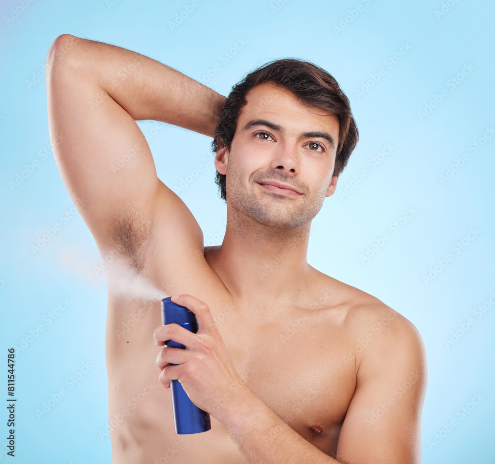 Grooming, man and deodorant in morning, routine and wellness in body care, hygiene and blue background. Male person, cosmetics and fresh for confidence, masculine and fragrance with product in studio Grooming, man and deodorant in morning, routine and wellness in body care, hygiene and blue background. Male person, cosmetics and fresh for confidence, masculine and fragrance with product in studio