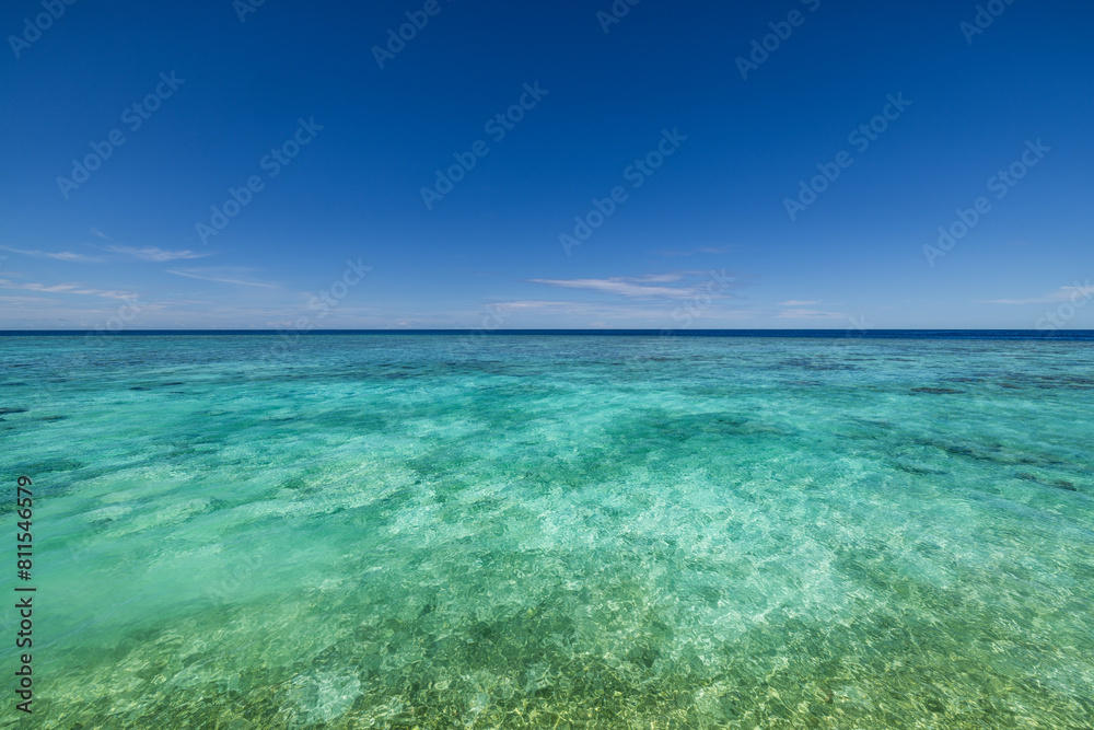 Crystal clear sea water bay. Pristine ocean lagoon sunny cloudy sky, idyllic relaxing seascape. Transparent surface, exotic travel. tropics Mediterranean nature panorama. Summer background, beach view