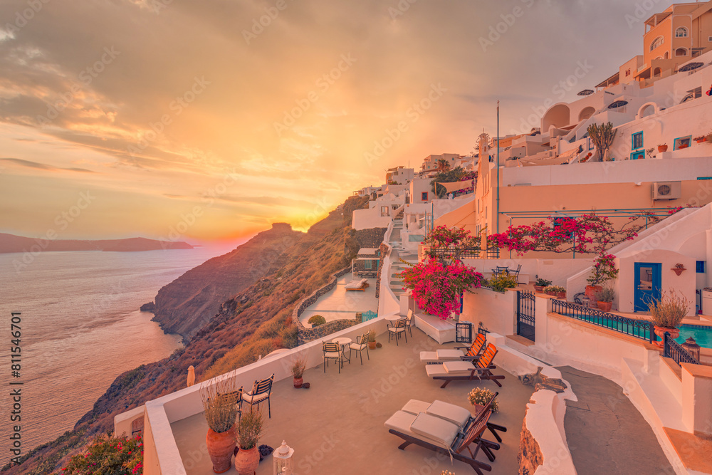 Oia village at night, Santorini island. Famous travel landscape, luxury vacation destination scenic. Beautiful view fabulous picturesque village colorful rays sky, traditional white houses, romantic