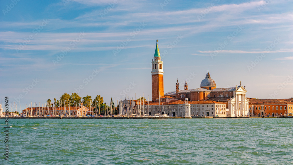 Venice, Italy. Beautiful Church of San Giorgio Maggiore and its Bell Tower at sunset illumination, and blue sky Venice, Italy. Beautiful Church of San Giorgio Maggiore and its Bell Tower at sunset illumination, and blue sky