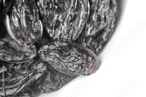 Dive into a world of culinary possibilities with this stunning close-up of black raisins, a staple ingredient in everything from trail mixes to tagines. Universal Flavors