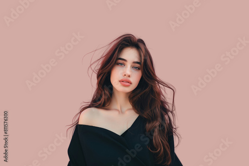A girl with long hair striking a pose against a vibrant pink background.