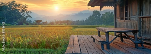 wooden table, hut, behind a rice field at sunset. photo