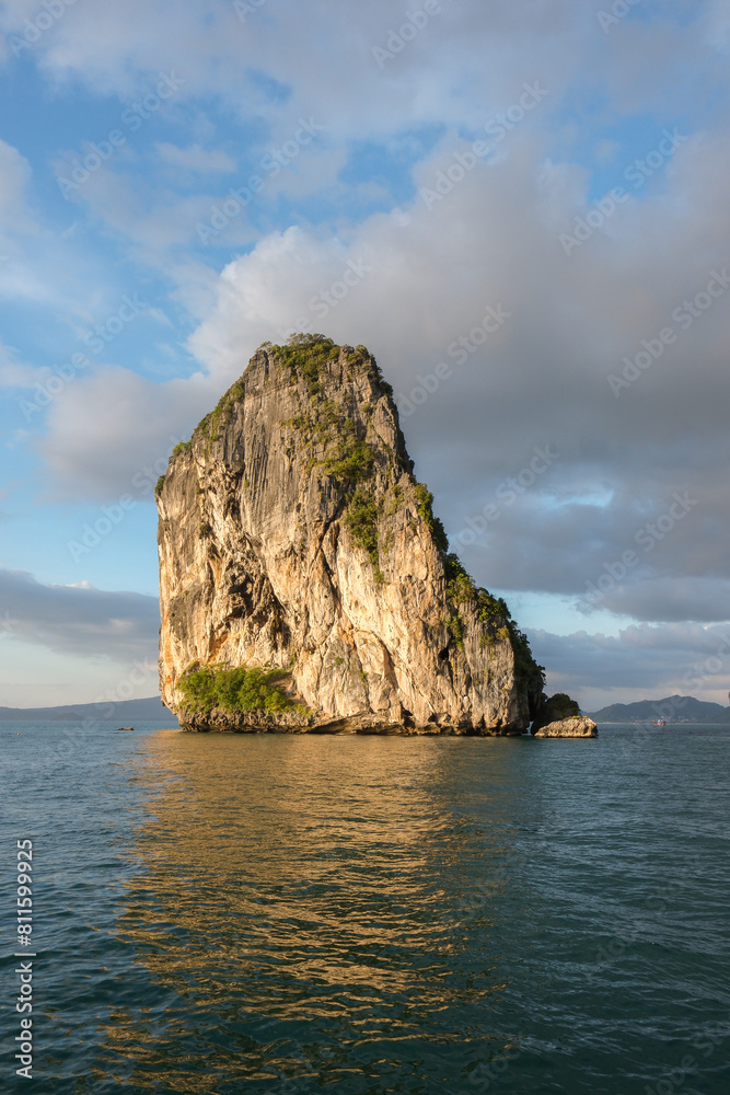 A limestone rock formation juts out of the ocean.