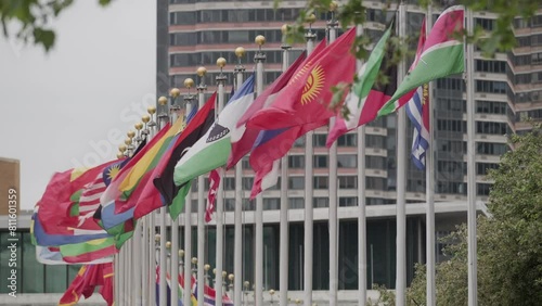 Line of national flags waving in front of the United Nations headquarters in New York City