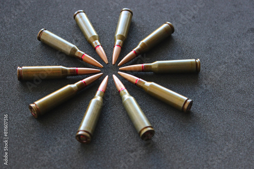 Circle Made With Bullets Laid Out In Head To Head Order On Black Velvet Upholstery Closeup View 